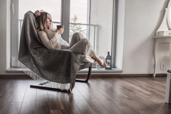 Junge Frau sitzt vor Schiebetür mit Wärmedammung