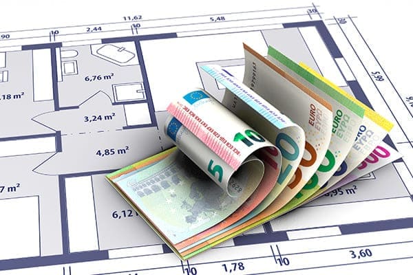 Hausbauplan mit Geldscheinen.
